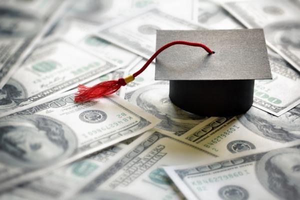 A graduation cap on $100 bills for student loans article